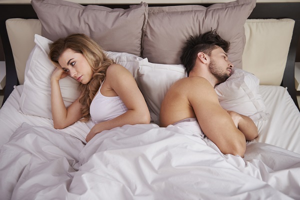 man and woman in bed upset because man has erectile dysfunction